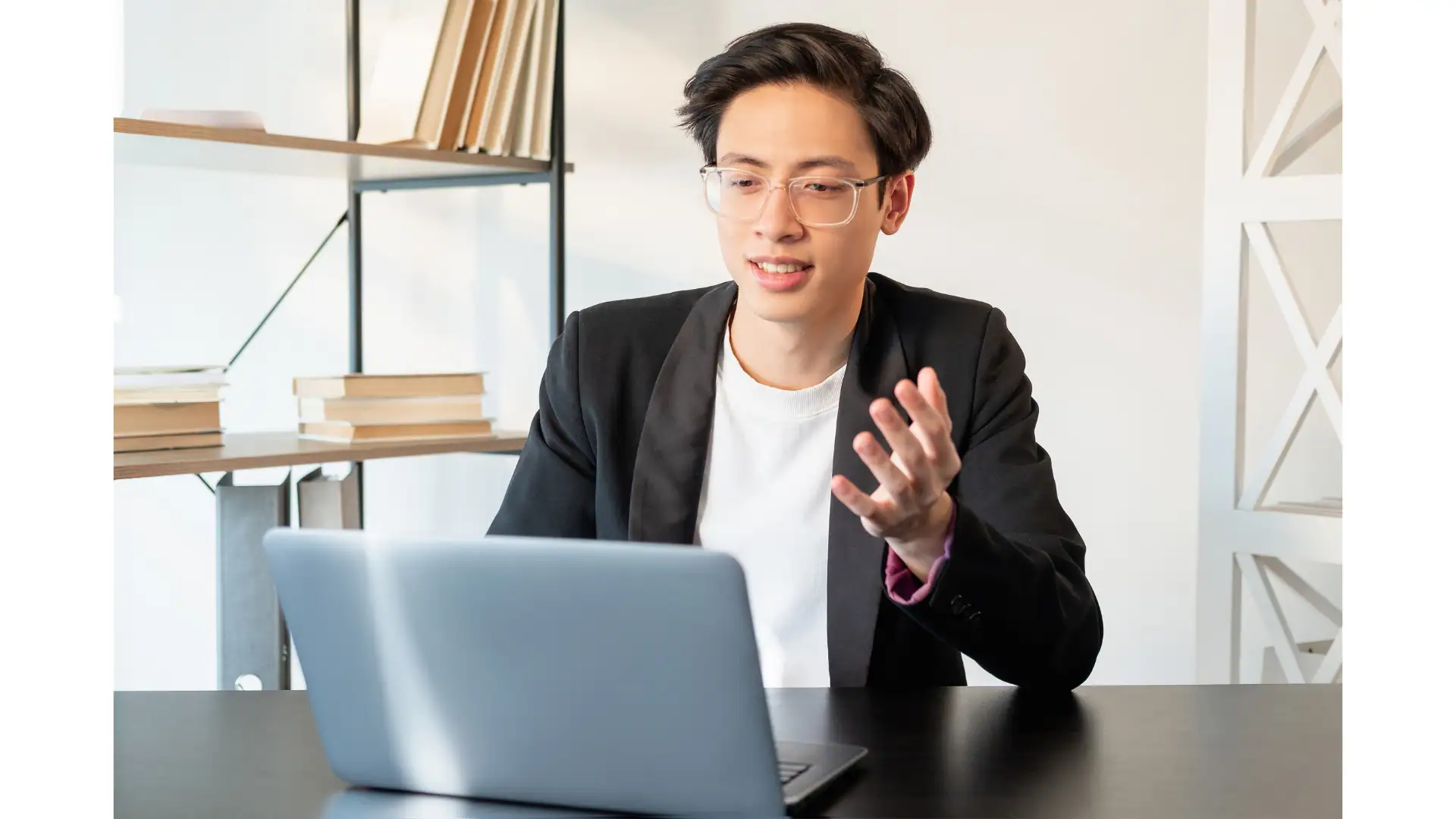 a man with glasses using laptop